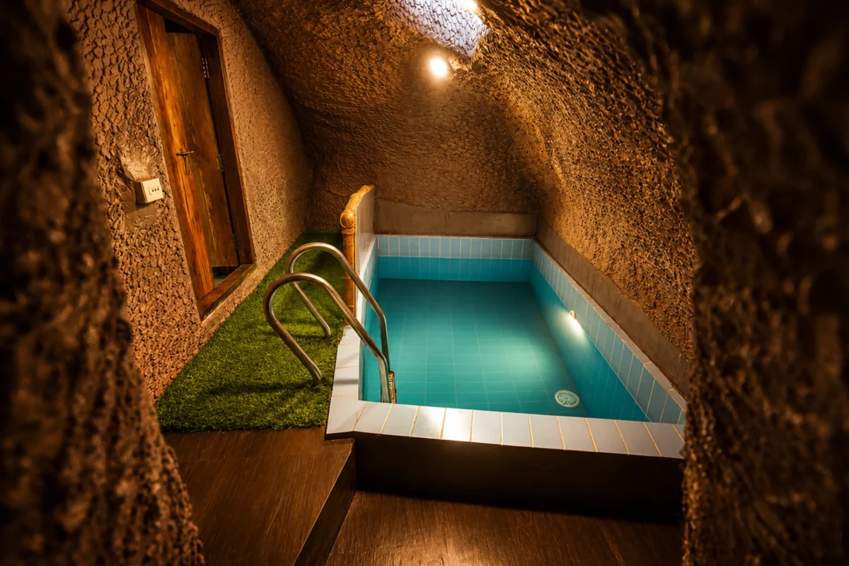 Private pool relaxation area and stone steps at Silver Oaks Cave House