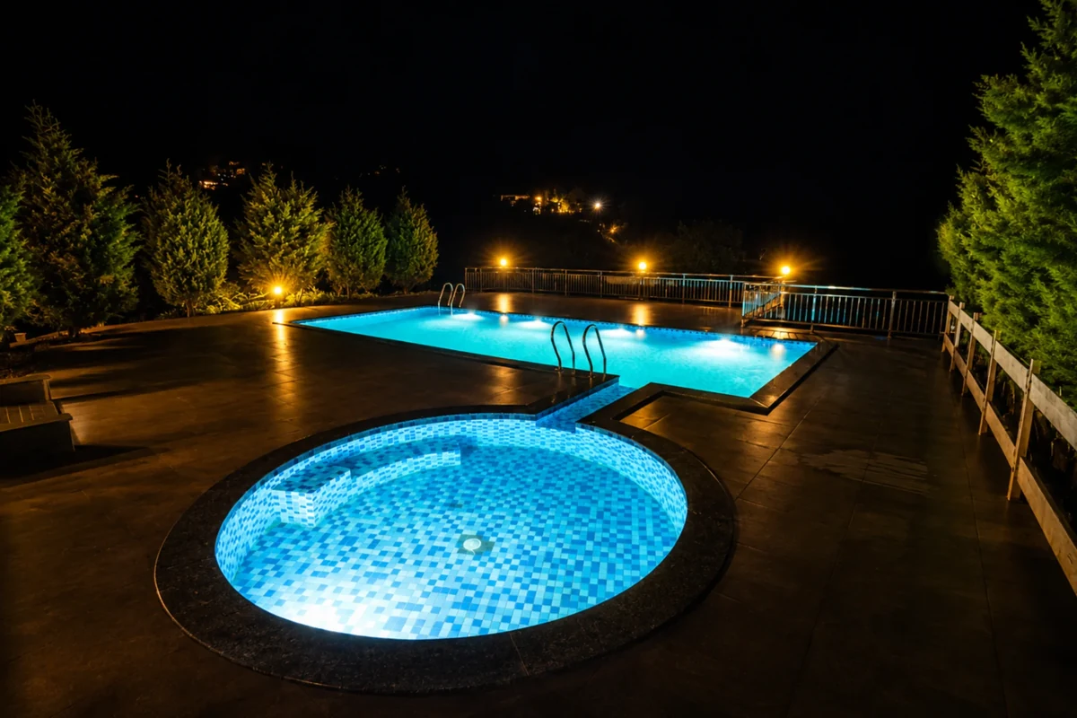 Scenic outdoor swimming pool surrounded by lush hills at Silver Oaks Munnar