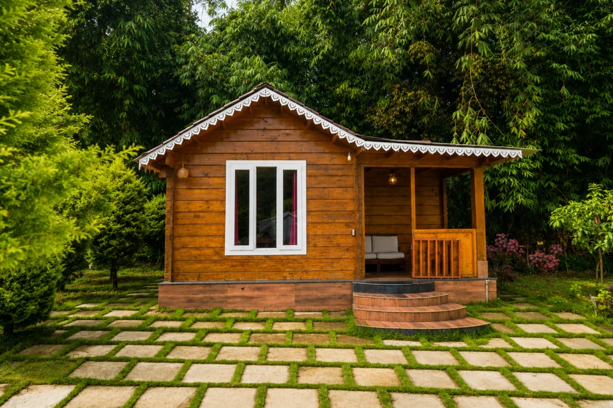 Wooden cottage balcony deck facing the rolling hills of Munnar